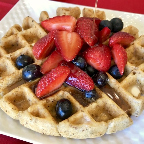 Gluten-Free Golden Waffles with Berries and Warm Cinnamon Syrup