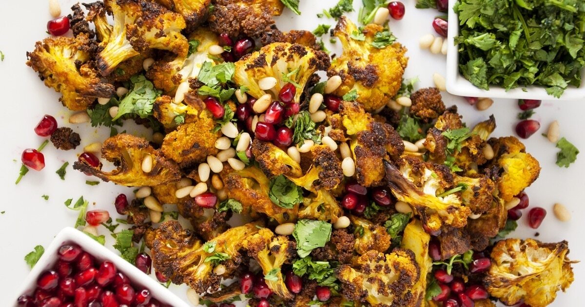 Roasted Turmeric Cauliflower With Cilantro and Mint | VegNews