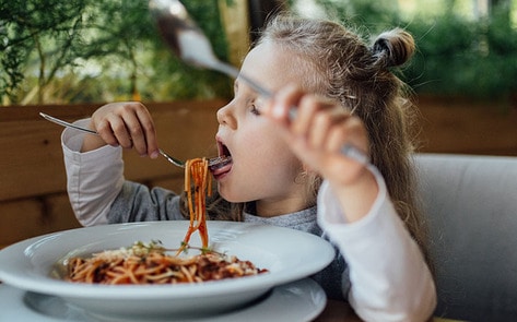 VegNews.KidEatingSpaghetti