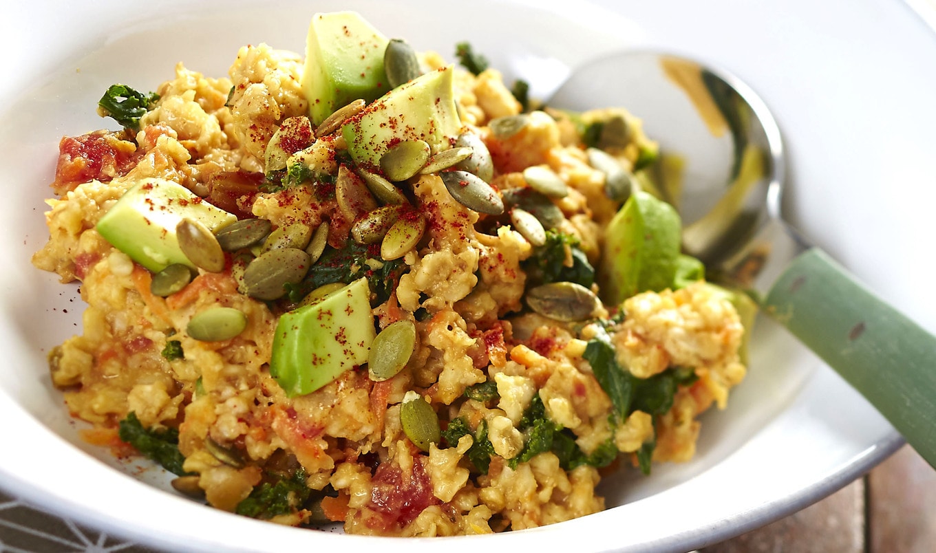 Savory Plant-Based Oatmeal Bowl With Cheesy Kale and Pumpkin Seeds