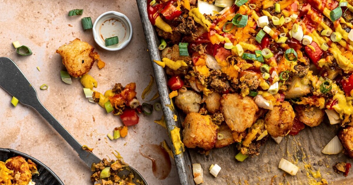 Vegan Cheeseburger Tater Tots With Cashew Cheddar Sauce | VegNews