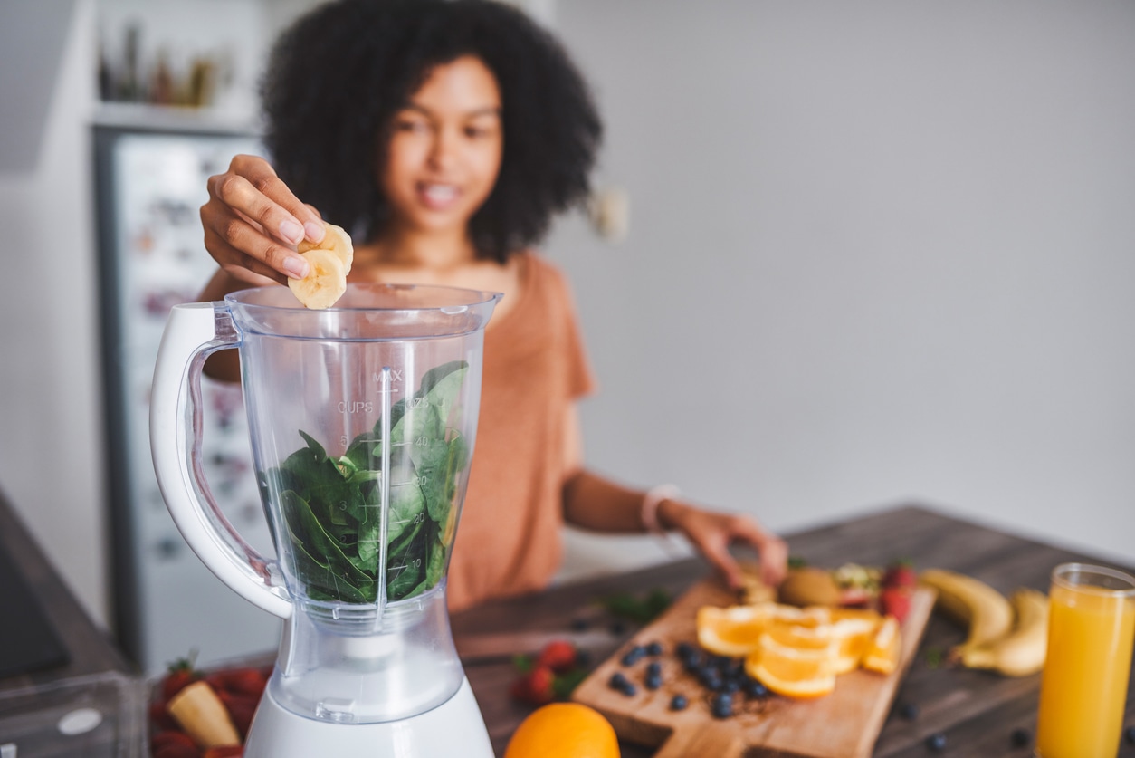 Woman Making Smoothie Blender