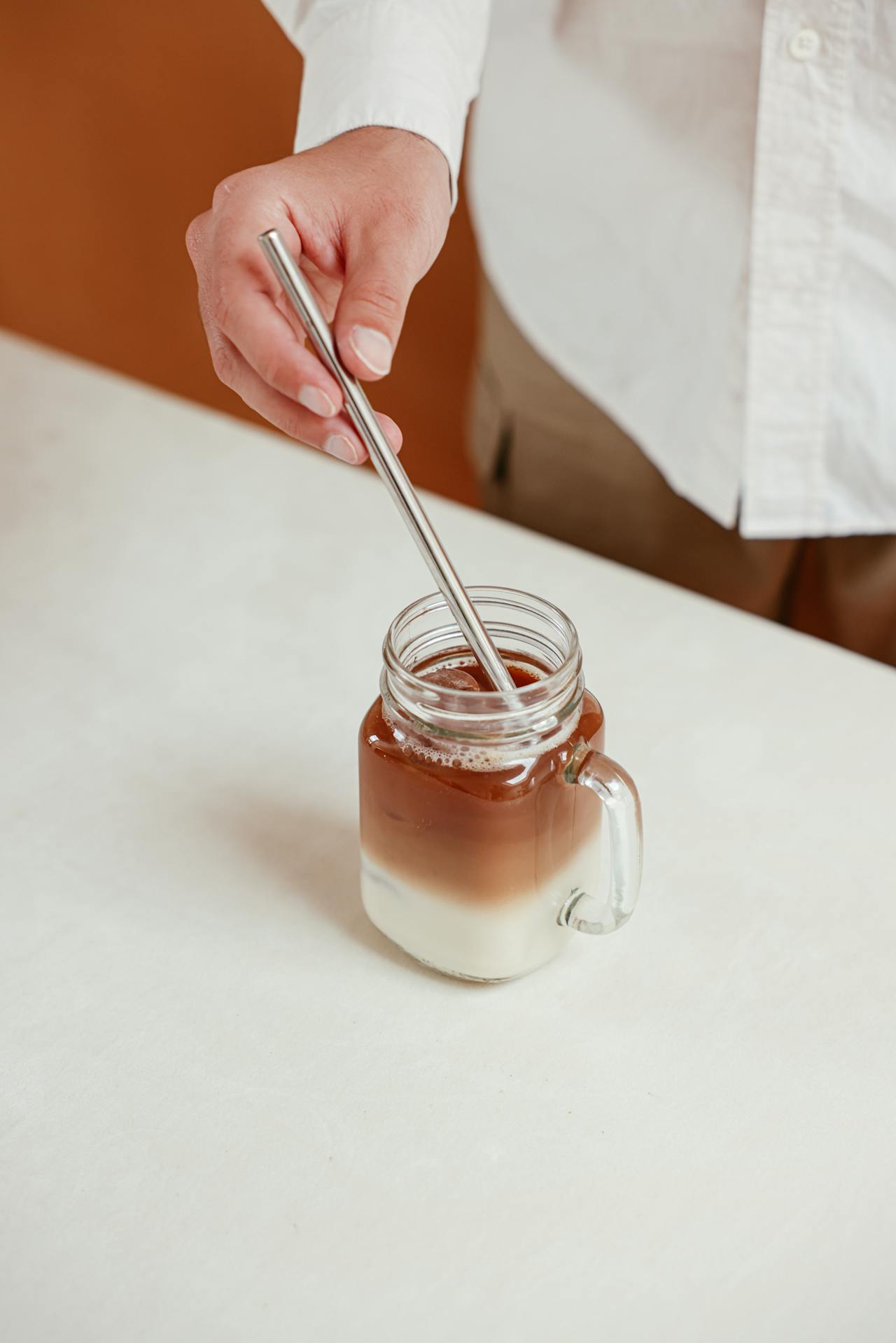 stirring iced latte