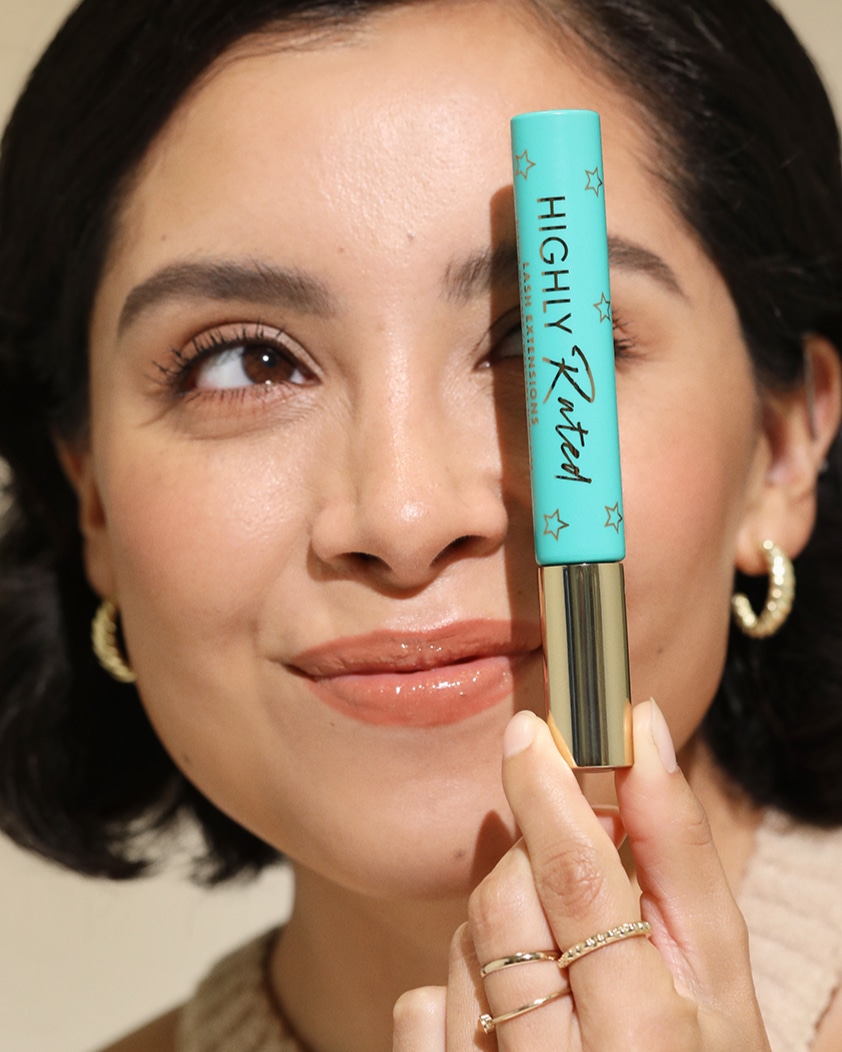 Woman holding Milani mascara 