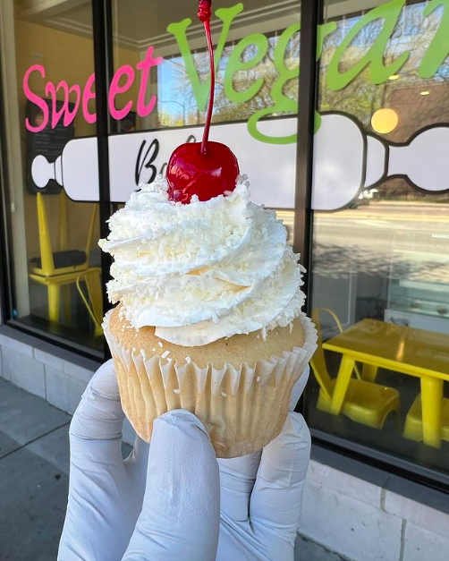 Coconut cupcake with cherry on top