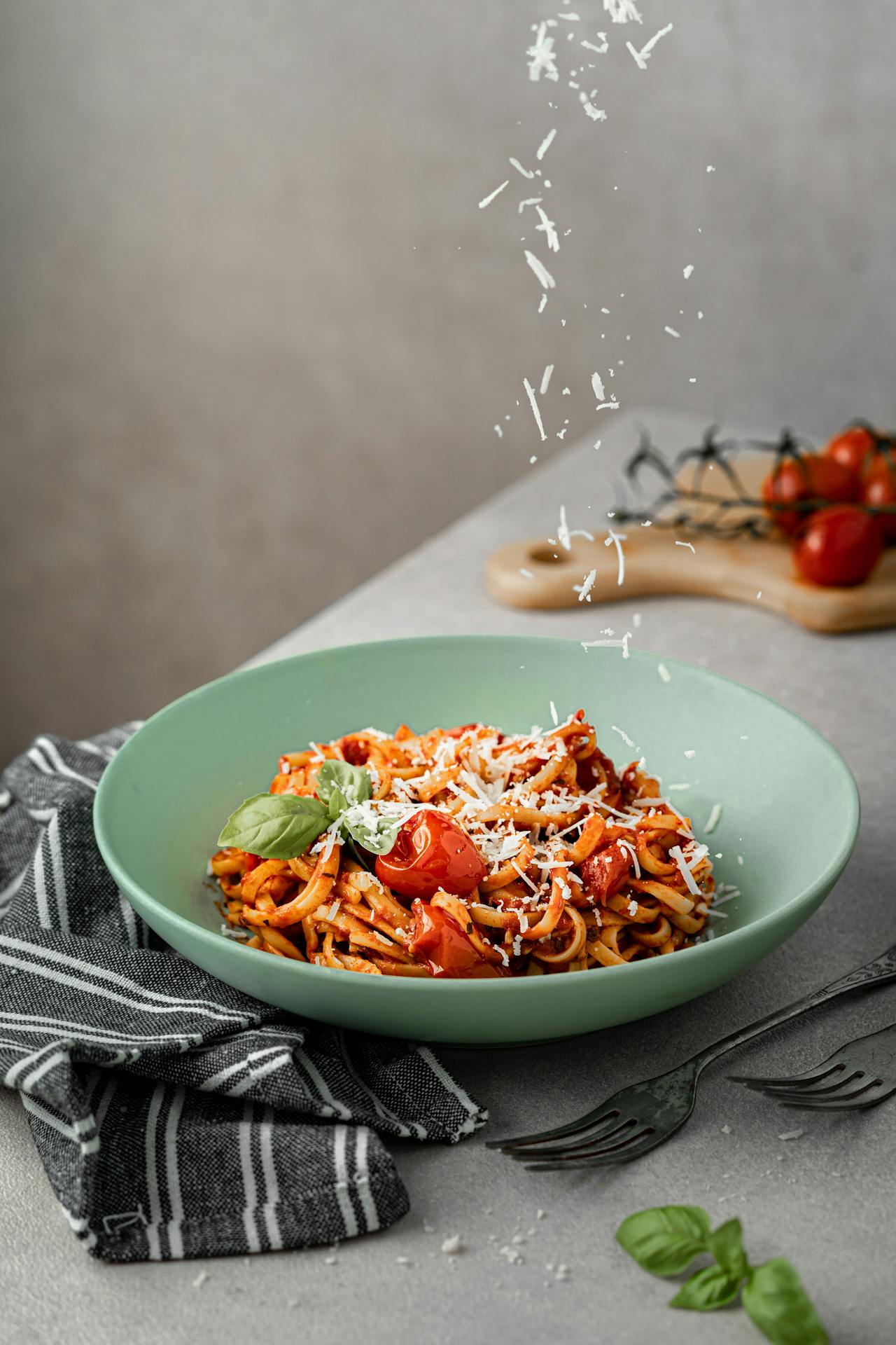 grating cheese on pasta