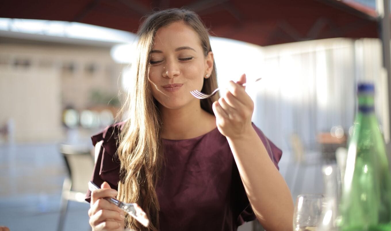 Woman eating with fork and knife