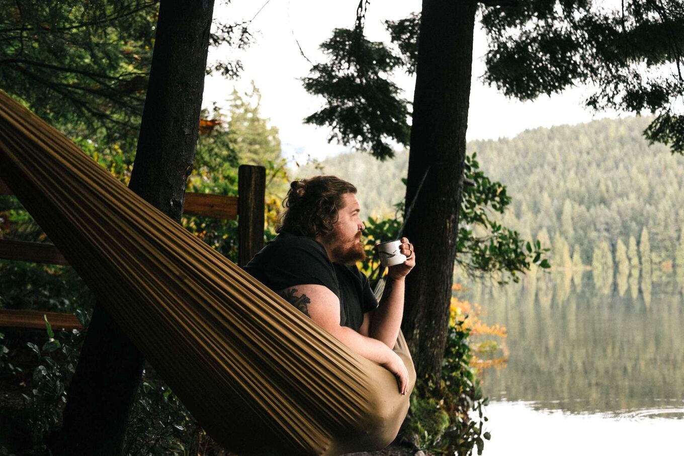 man on hammock with tea