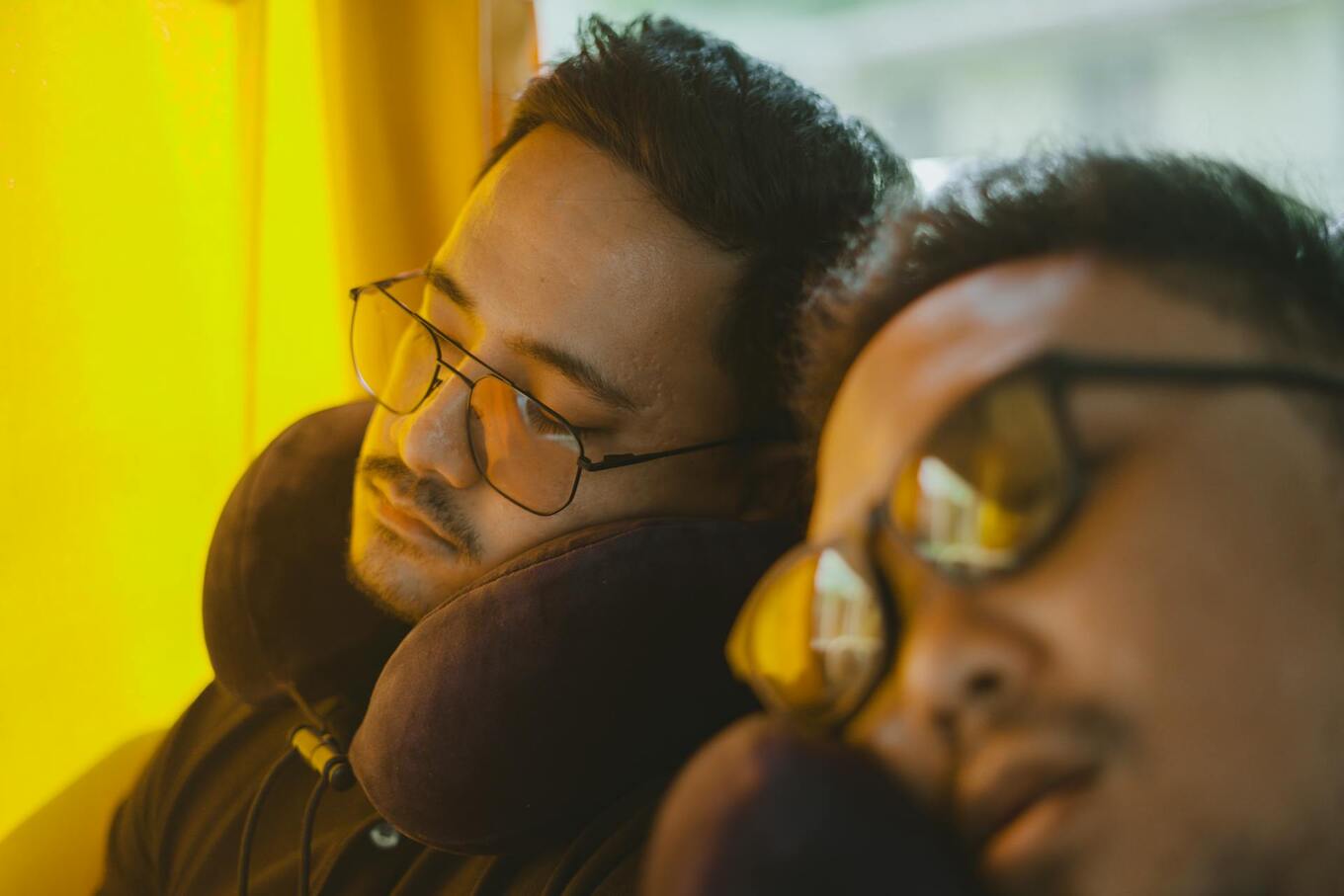 men sleeping with travel pillow