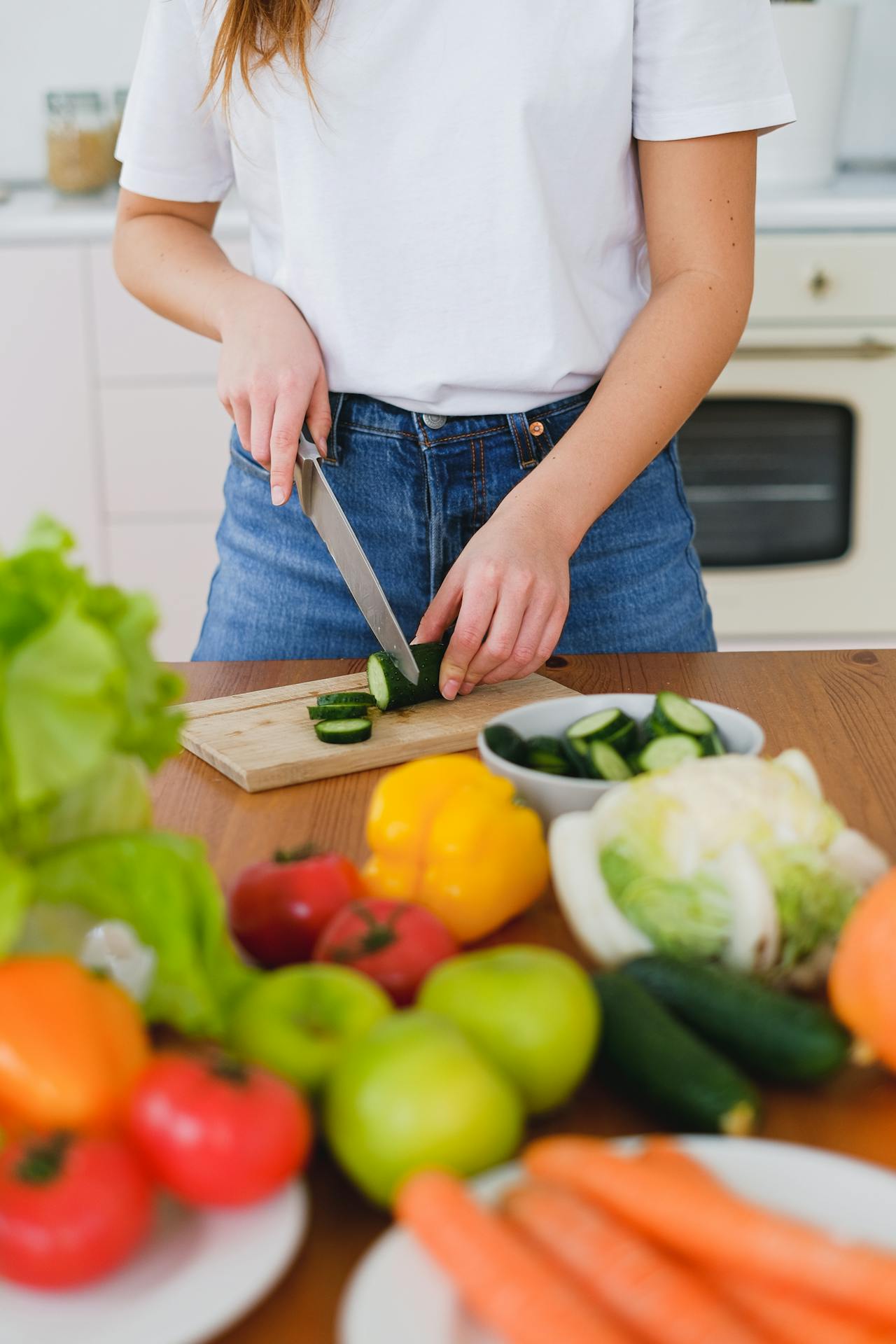woman cutting cucumber