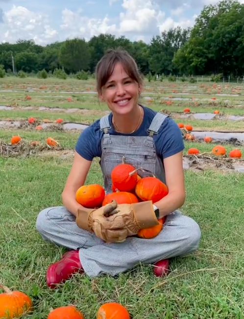Jennifer Garner on her farm holding pumpkins