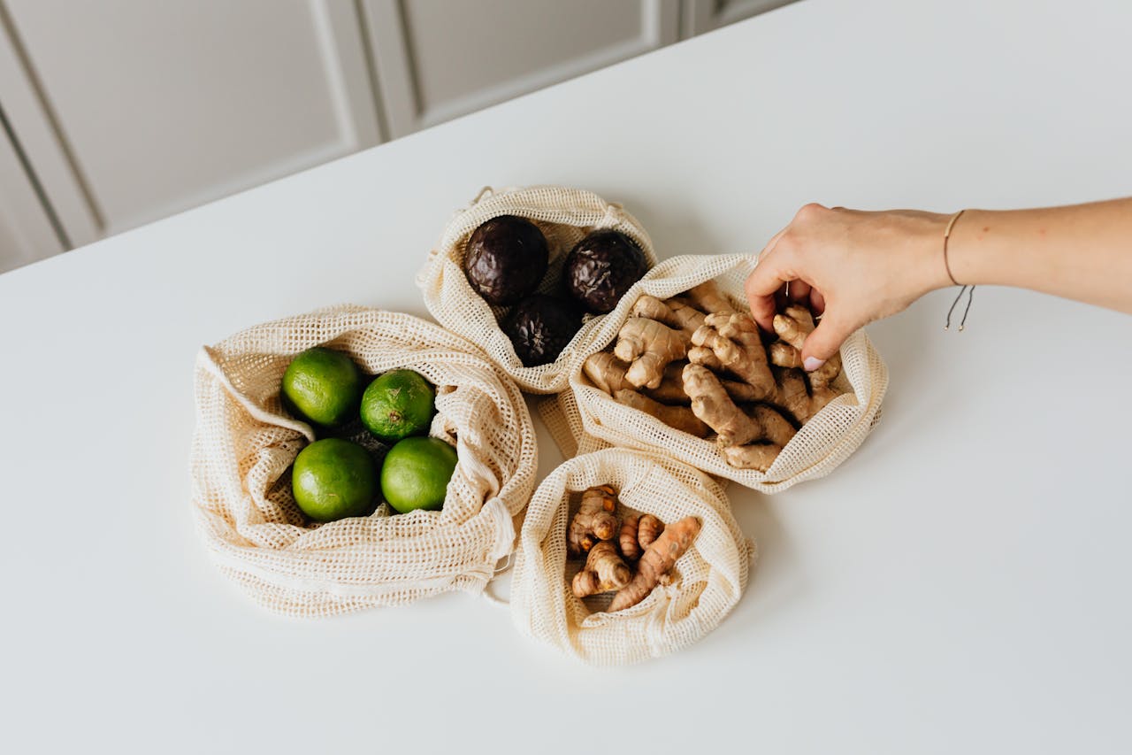 person reaching for produce in bags