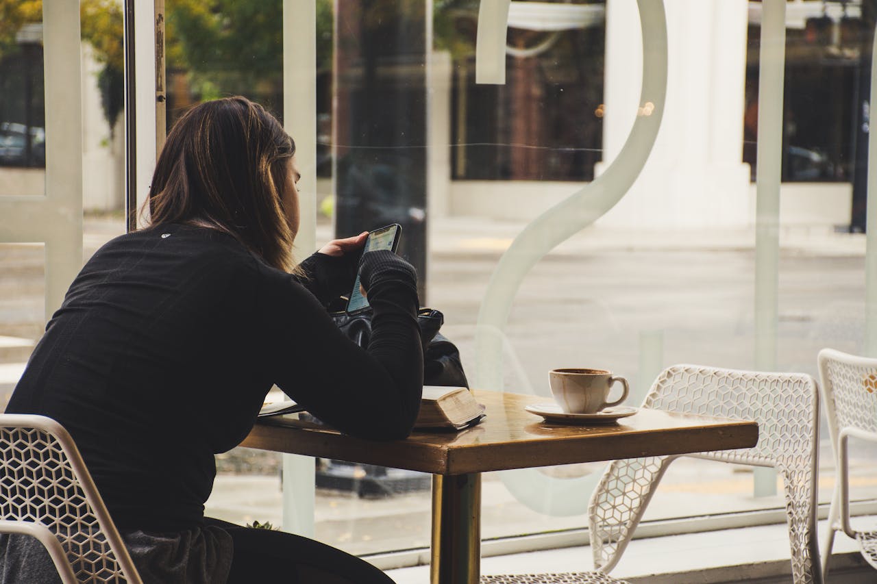 woman on phone in coffee shop
