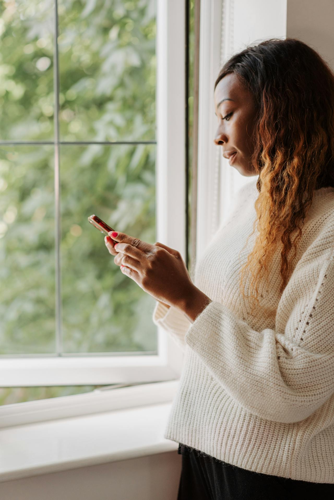 woman scrolling by window