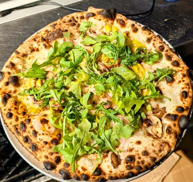 vegan pizza topped with greens