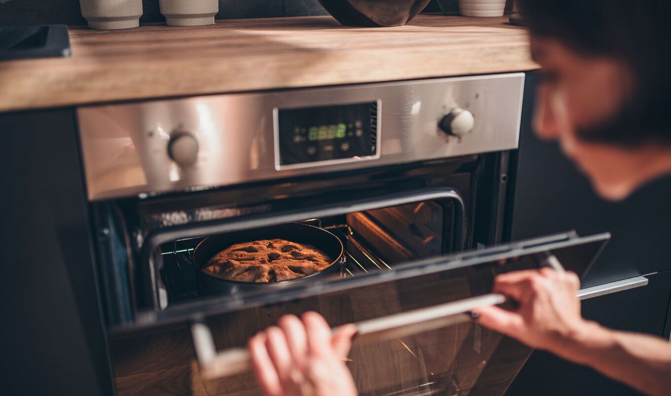 woman baking using oven