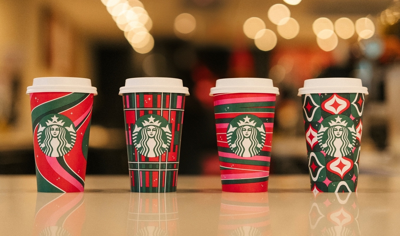 Starbucks Christmas espresso cups next to Nespresso machine