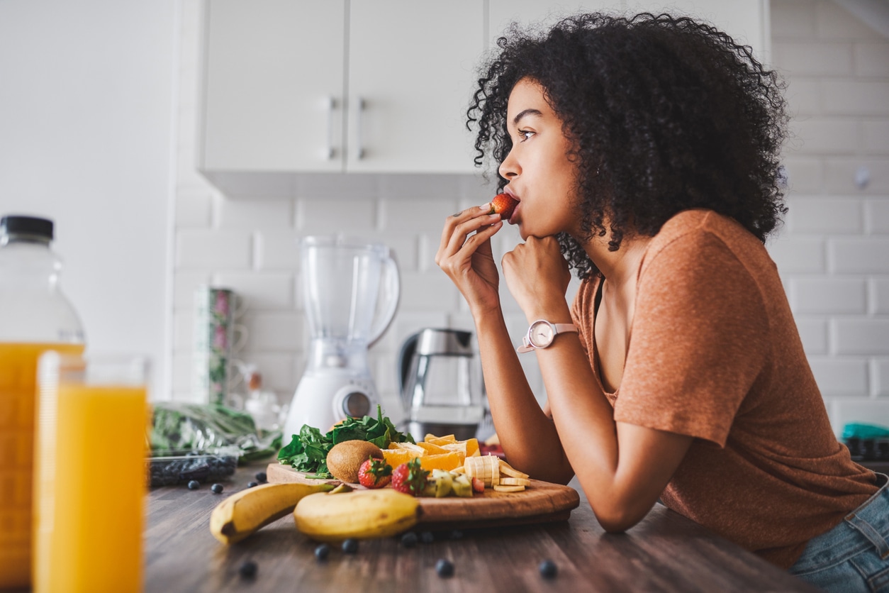 VegNews.WomanEatingFruit.Getty
