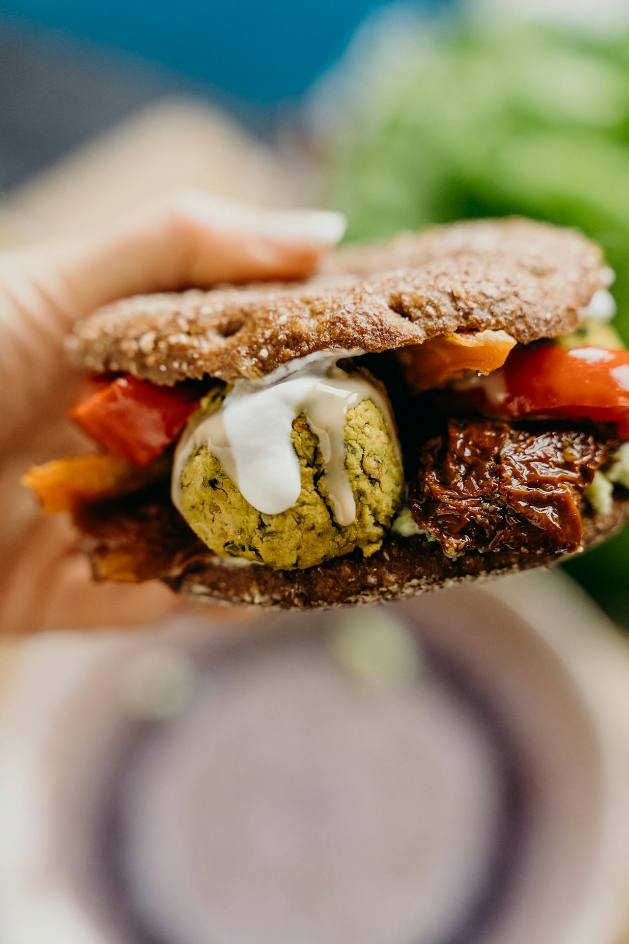 holding pita with falafel