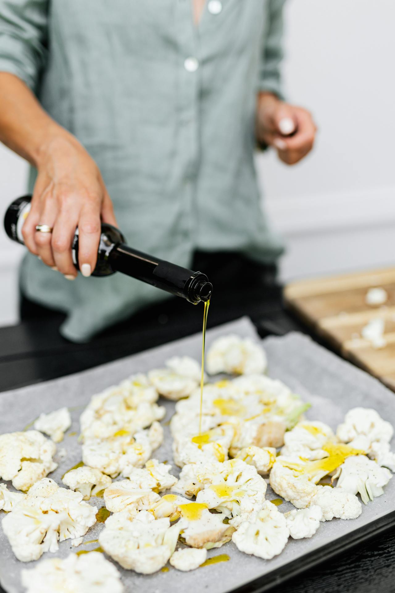 pouring oil on cauliflower