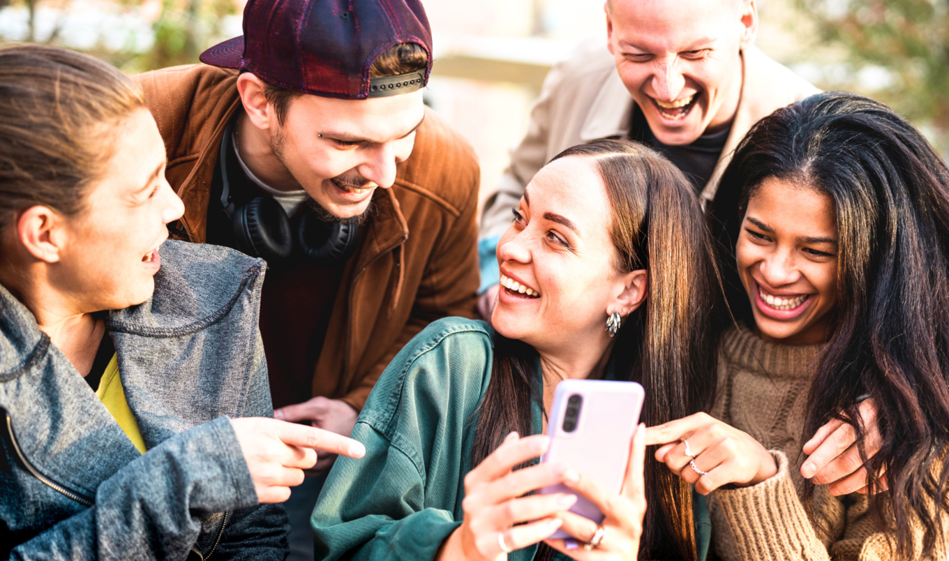 friends gather around phone