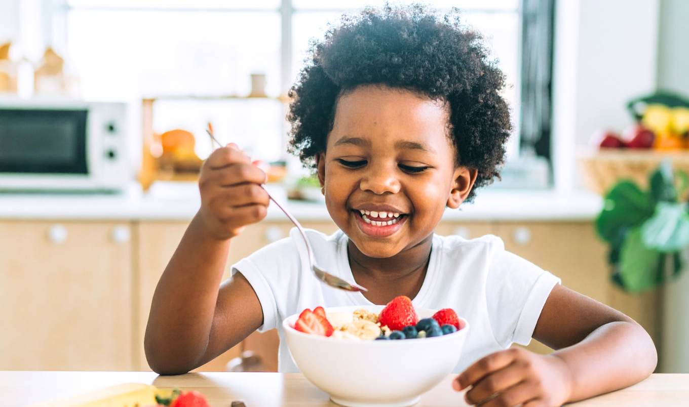 kid eating bowl of fruit