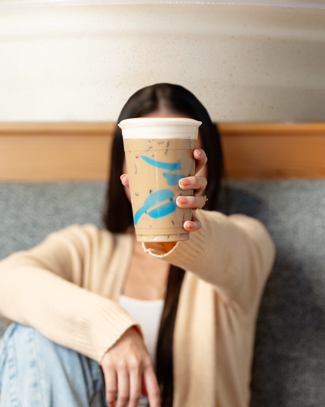 woman holds Caribou coffee
