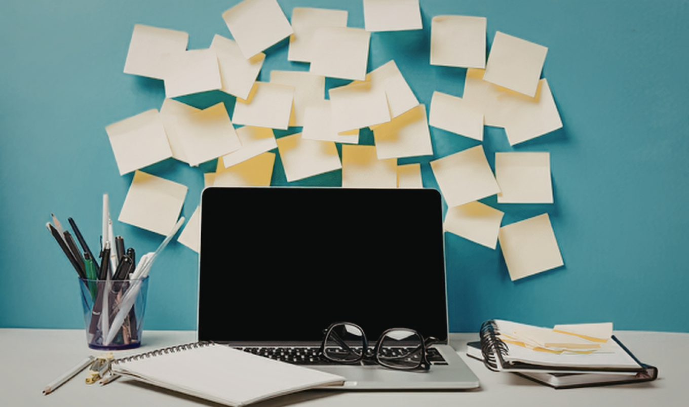 messy laptop workspace.Canva.Steliana-Ardelean