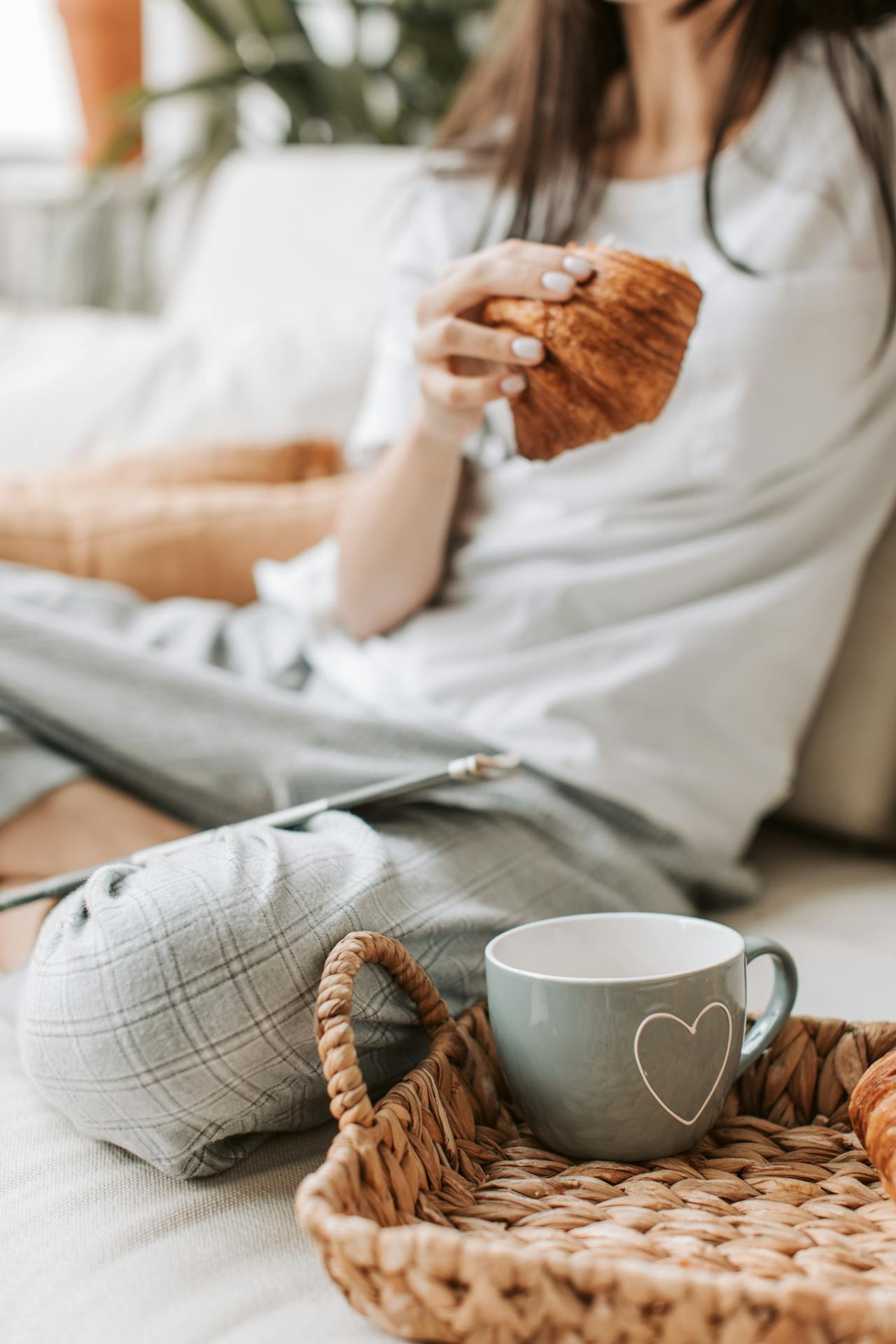 woman sat on floor holding pastry