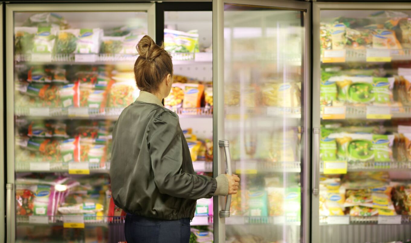 woman in freezer aisle at grocery store