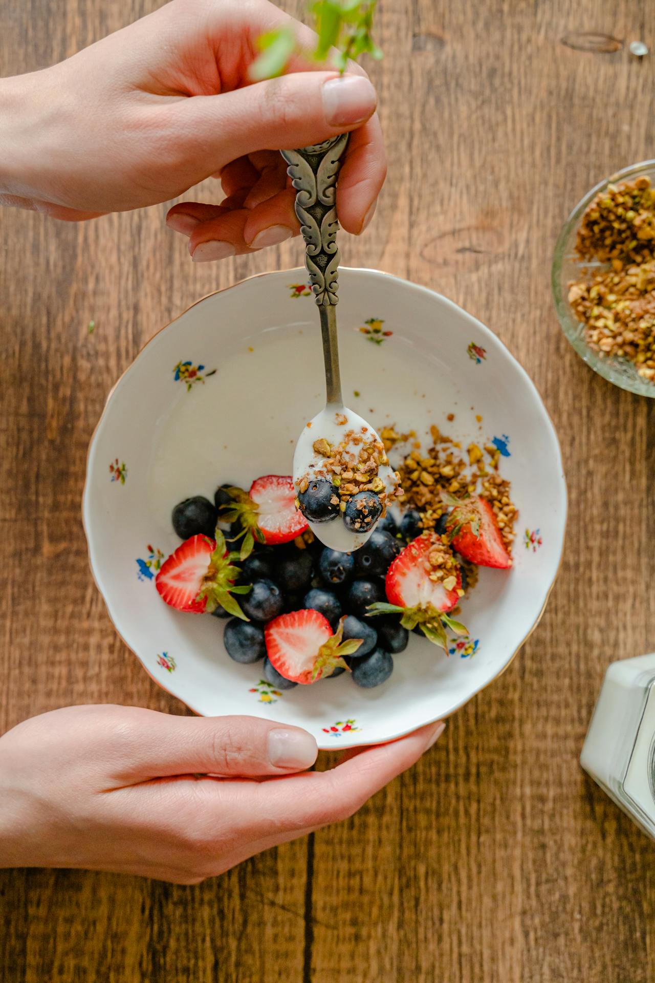 eating bowl of fruit and yogurt