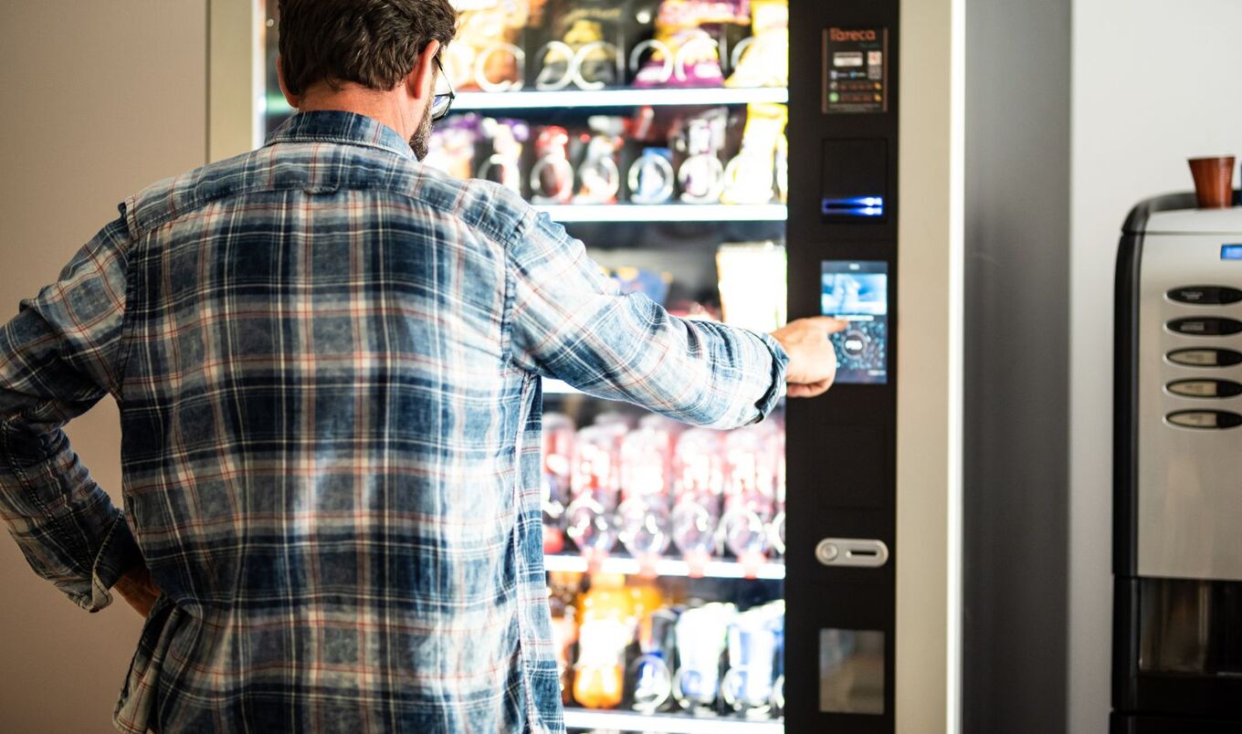 man buying from vending machine